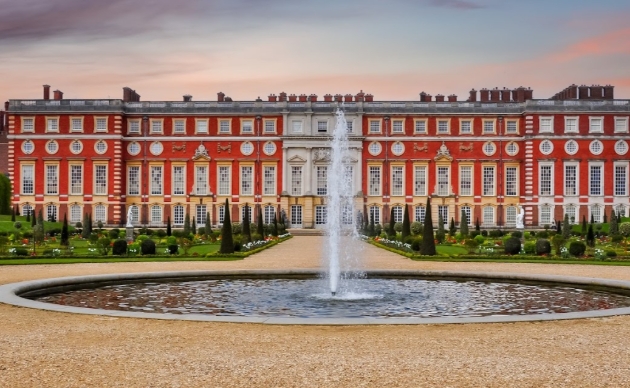 large red brick building with water fountain