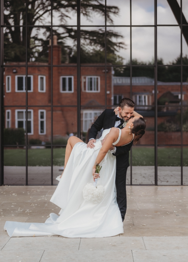 bride and groom outside venue dancing