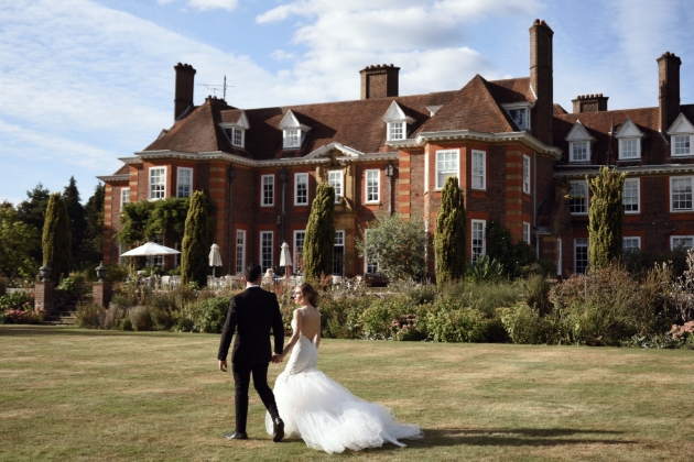Barnett Hill outside shot of couple walking across grass