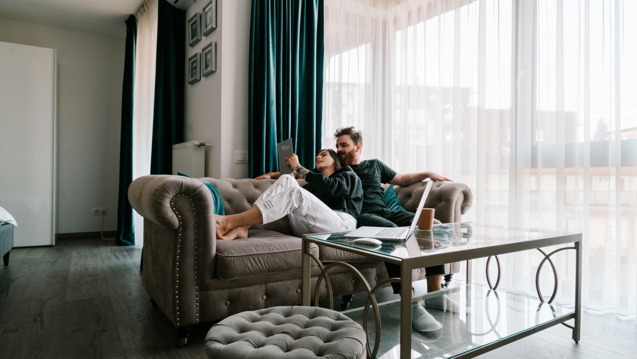 young couple on sofa in their apartment