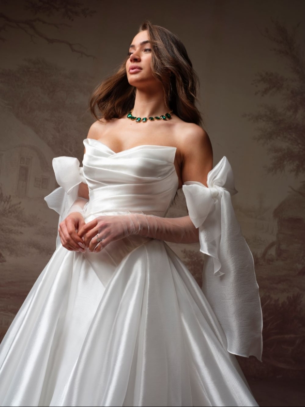 Striking asymmetrically draped bodice V-neckline bridal gown